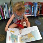 E.V. reads Curious George to Curious George.